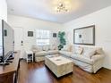 Spacious living room with light beige sectional sofa and wood floors at 5362 Diplomat Ct # 103, Kissimmee, FL 34746