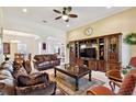 Spacious living room with leather sofas, built in shelving and large TV at 804 San Raphael St, Poinciana, FL 34759