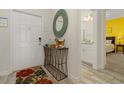 Bright entryway with decorative mirror and contemporary console table at 3060 Gatsby St, Kissimmee, FL 34746