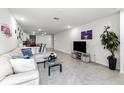 Open concept living room, featuring a comfortable sectional sofa and a large TV at 2928 Sunridge Loop, Saint Cloud, FL 34771