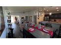 Open concept dining area with kitchen and living room at 305 Cascara Ln, Auburndale, FL 33823