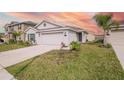 Light gray house exterior with attached garage at 132 Pineywoods St, St Cloud, FL 34772