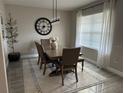 Elegant dining room with large clock and modern chandelier at 3181 Royal Tern Dr, Winter Haven, FL 33881