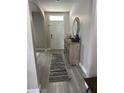 Bright entryway with wood-look floors and a console table at 3181 Royal Tern Dr, Winter Haven, FL 33881
