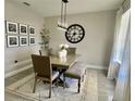 Bright dining room with a large clock and modern chandelier at 3181 Royal Tern Dr, Winter Haven, FL 33881