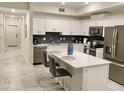 Modern kitchen with stainless steel appliances, an island, and ample counter space at 3131 Paradox Circle # 207, Kissimmee, FL 34746
