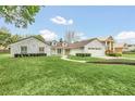A charming house with stone exterior, neatly landscaped lawn and a welcoming front entrance at 7920 Summer Ridge Pl, Orlando, FL 32819