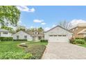 This home boasts a beautiful stone exterior, a large driveway, and well-manicured landscaping at 7920 Summer Ridge Pl, Orlando, FL 32819