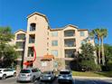 Exterior view of the building with parking area at 8010 Tuscany Way # 3103, Davenport, FL 33896