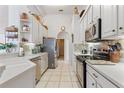 Bright kitchen boasts stainless steel appliances and ample counter space at 100 Moss Ln, Davenport, FL 33837