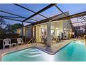 Relaxing backyard oasis featuring a large pool and covered patio at 100 Moss Ln, Davenport, FL 33837