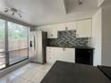 Modern kitchen with stainless steel appliances and a tile backsplash at 824 Park Lake Pl # 824, Maitland, FL 32751