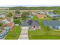 Aerial view of a house with solar panels, showcasing its curb appeal and neighborhood setting at 617 Brockton Dr, Kissimmee, FL 34758