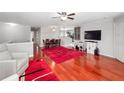 Spacious living area with hardwood floors and red rug at 1001 Via Capri Ln # 204, Celebration, FL 34747