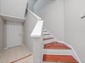 Modern staircase with wood flooring and white railings at 1001 Via Capri Ln # 204, Celebration, FL 34747