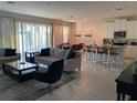 Open concept living room with modern furniture and kitchen at 7441 Marker Ave, Kissimmee, FL 34747