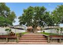 Brick patio and steps leading to a spacious backyard with a large tree and privacy fence at 10233 Serotina Ct, Orlando, FL 32832
