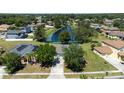 Aerial view of house and neighborhood with pond at 3260 Marshfield Preserve Way, Kissimmee, FL 34746