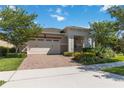 House exterior featuring a two-car garage and landscaping at 4921 Catalpa Dr, St Cloud, FL 34772