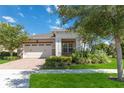 House exterior featuring a two-car garage and landscaping at 4921 Catalpa Dr, St Cloud, FL 34772