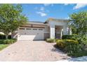 House exterior featuring a two-car garage and landscaping at 4921 Catalpa Dr, St Cloud, FL 34772