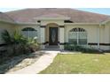 Home's entrance with arched entryway and landscaping at 4572 Nw 32Nd St, Ocala, FL 34482