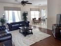 Spacious living room featuring hardwood floors and a comfortable leather sofa at 7953 Sea Pearl Cir, Kissimmee, FL 34747