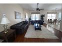 Bright living room with hardwood floors, a large sofa, and access to dining area at 7953 Sea Pearl Cir, Kissimmee, FL 34747