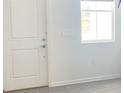 Bright entryway with white door and gray tile flooring at 7645 Danube Rd, Kissimmee, FL 34747