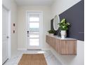 Bright and airy entryway with modern console table and mirror at 4577 Target Blvd, Kissimmee, FL 34746