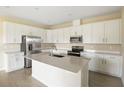 Modern kitchen with white cabinets, quartz countertops, and stainless steel appliances at 2204 Mac Blvd, Eagle Lake, FL 33839
