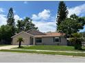 Tan one-story house with a two-car garage and landscaping at 866 Crows Bluff Ln, Sanford, FL 32773