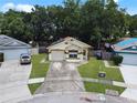 Aerial view of a single-story house with a yard and driveway at 2912 Willow Oak Ct, Kissimmee, FL 34744