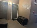 Building entryway with gray doors and package storage at 6141 Metrowest E Blvd # 303, Orlando, FL 32835