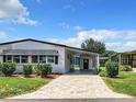 Front view of a white manufactured home with landscaping at 1518 Longbow Dr, Lakeland, FL 33810