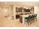 Modern kitchen with dark cabinets, granite island, and stainless steel appliances at 2022 Majorca Dr, Kissimmee, FL 34747