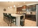 Modern kitchen with dark cabinets, granite island, and stainless steel appliances at 2022 Majorca Dr, Kissimmee, FL 34747