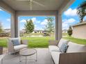Covered patio overlooking a lake with comfortable seating at 3241 Wauseon Dr, St Cloud, FL 34772