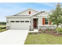 Curb appeal of a single-story home with landscaping at 151 Bull Frog Ln, Umatilla, FL 32784