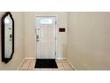 Home entryway with mirror and door to the interior at 2131 Tripoli Ct, Kissimmee, FL 34747