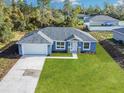 Newly built home with a two-car garage and landscaped yard at 16617 Sw 31St Cir, Ocala, FL 34473