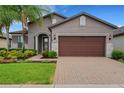 Single-Gathering home with landscaped yard and brick driveway at 668 Cordoba Dr, Davenport, FL 33837