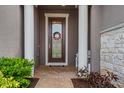 Inviting entryway with decorative door and stone accents at 668 Cordoba Dr, Davenport, FL 33837