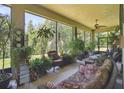 Relaxing sunroom filled with plants and comfortable seating at 806 Ebb Tide Ln, Poinciana, FL 34759