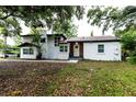 White two-story house with mature trees and landscaping at 1419 36Th St, Orlando, FL 32839