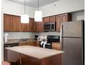 Modern kitchen with granite countertops and stainless steel appliances at 12539 Floridays Resort Dr # 305-D, Orlando, FL 32821