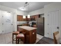 Modern kitchen with granite countertops and stainless steel appliances at 12539 Floridays Resort Dr # 305-D, Orlando, FL 32821