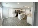 Modern kitchen with island, stainless steel appliances, and granite countertops at 705 Harland Ct, Kissimmee, FL 34758
