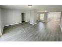 Spacious living room with gray vinyl plank flooring at 705 Harland Ct, Kissimmee, FL 34758