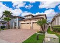 Two-story house with a three-car garage and nicely landscaped front yard at 2518 Fontaine Dr, Kissimmee, FL 34741